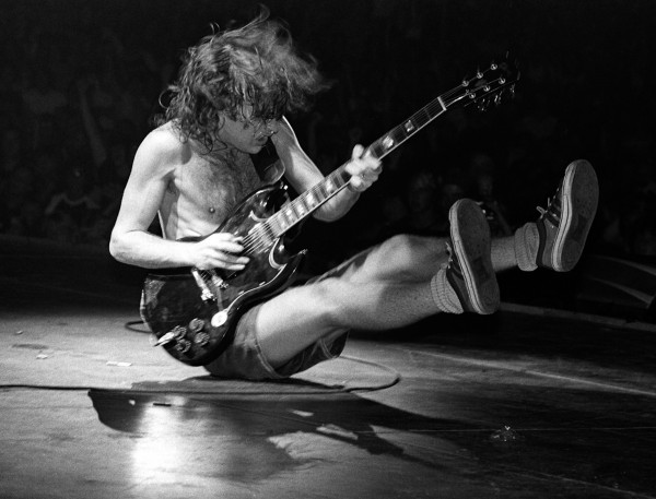 young angus young playing on the floor rare photo