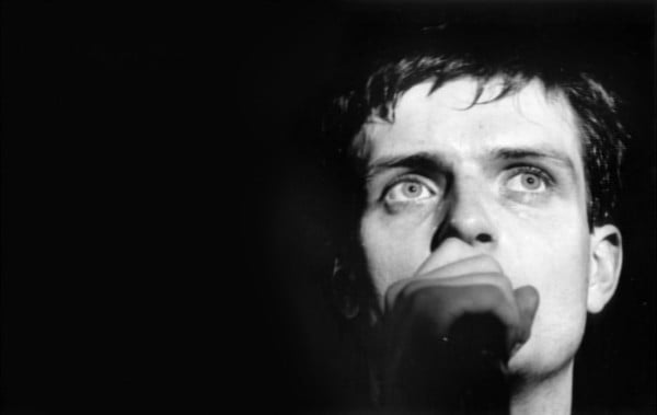 ian curtis on stage blue eyes close plan