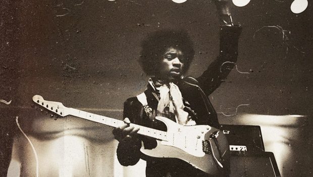 Jimi Hendrix playing a right hand guitar upside down.