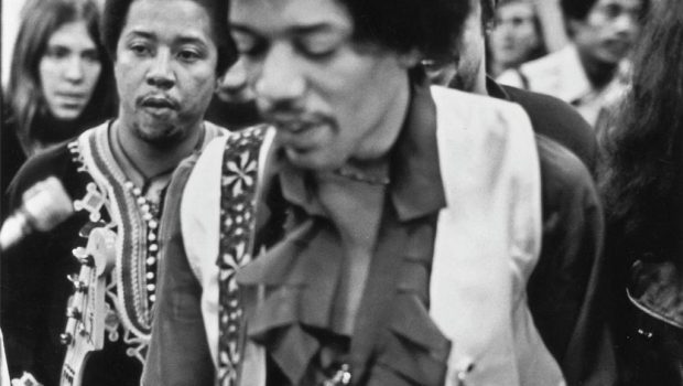Jimi Hendrix with his guitar, followed by his friend Billy Cox