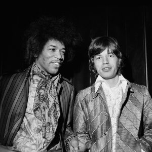 Jimi Hendrix and Mick Jagger casually socializing as friends.