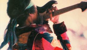 Jimi Hendrix Palying Guitar With Teeth Wallpaper