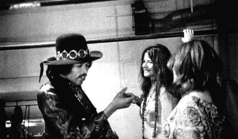 "Janis Joplin and Jimi Hendrix smiling and holding hands backstage at Winterland, 1968.
