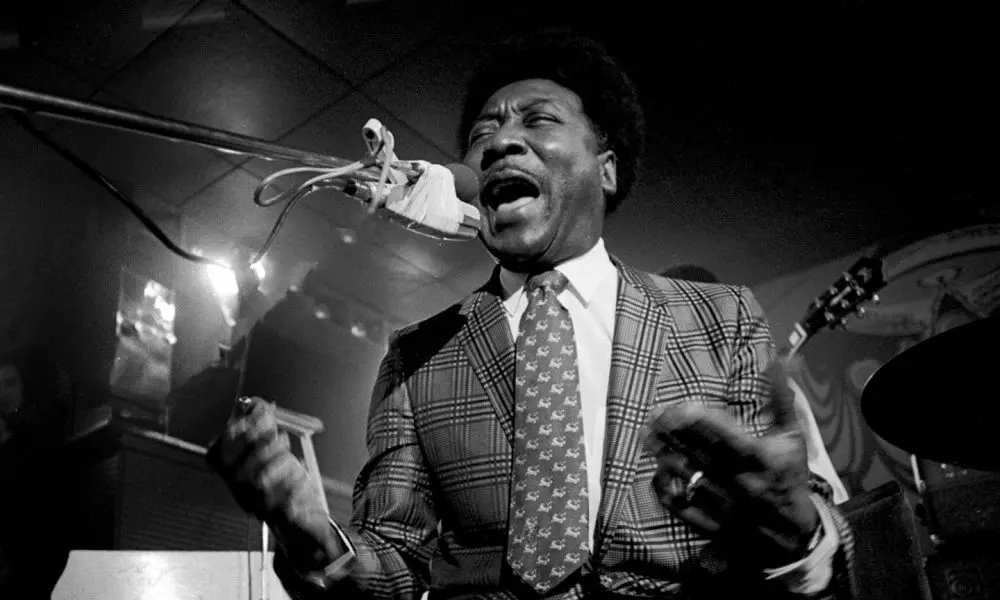 Muddy Waters singing into a microphone