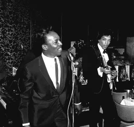 Wilson Pickett singing on stage with a young Jimi Hendrix playing the guitar behind him, in New York City, 1966.