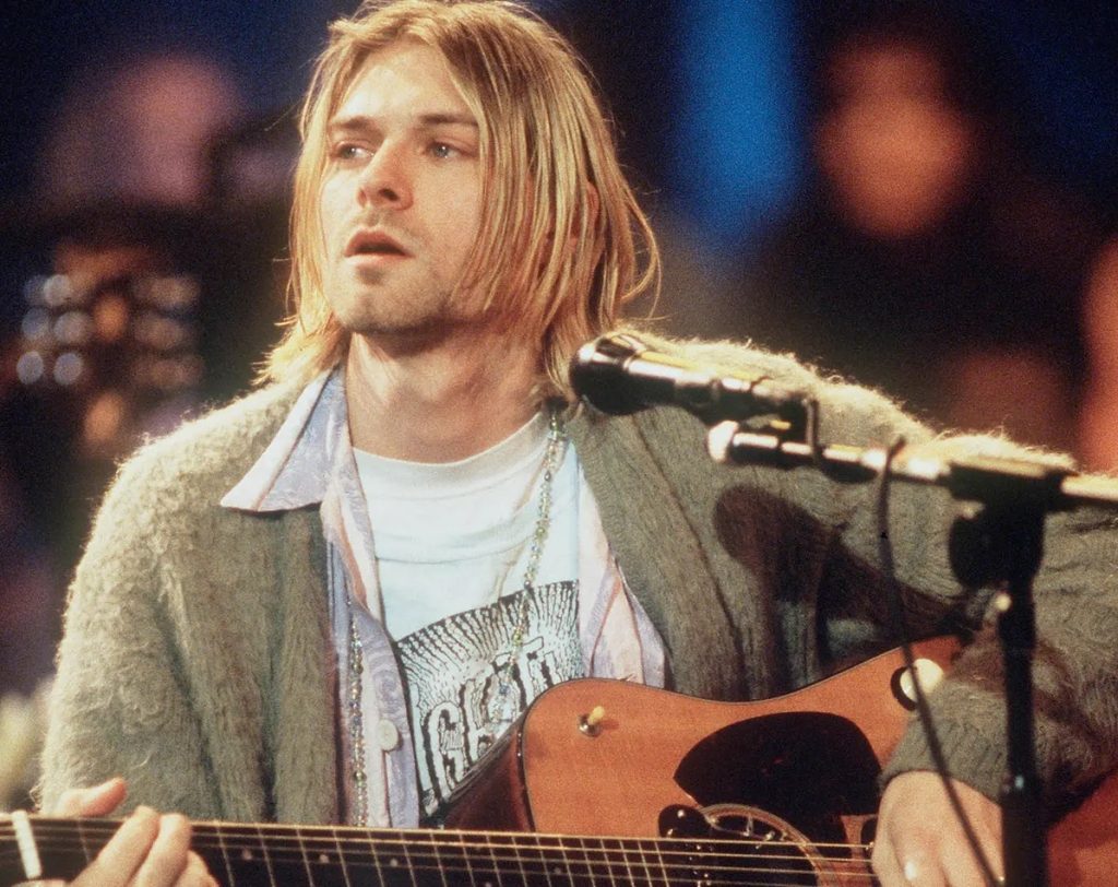 Kurt Cobain holding his Martin D-18E guitar during the MTV Unplugged in New York performance.