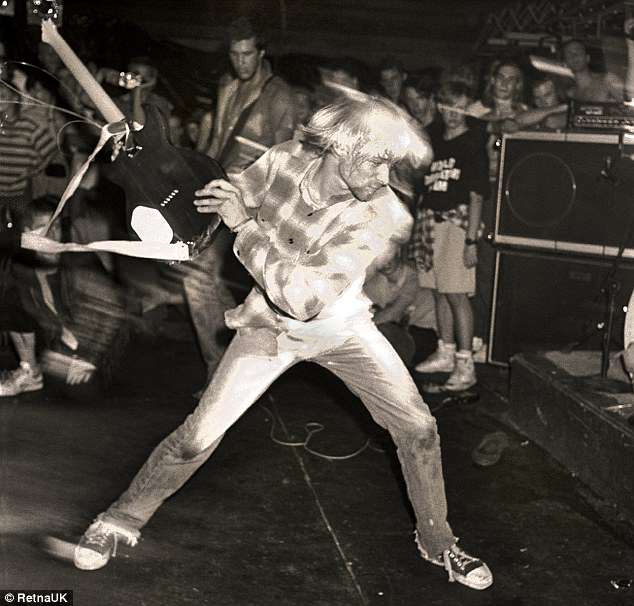 Kurt Cobain smashing a guitar on stage during a performance in Seattle in September 1990