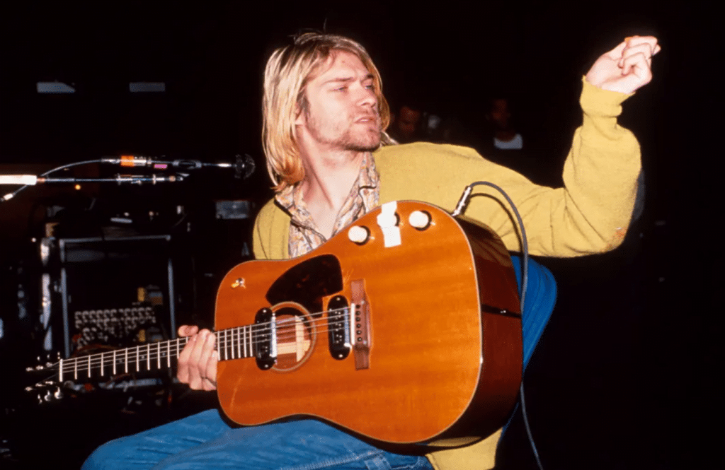 Kurt Cobain playing guitar in a scene from the biopic Montage Of Heck.