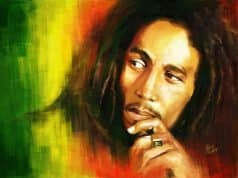 A high-definition wallpaper featuring Bob Marley with the vibrant colors of the Jamaican flag in the background.