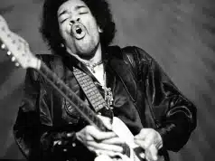 A stylized graphic depiction of Jimi Hendrix, showcasing his signature style and electric charisma, suitable for use as a background.